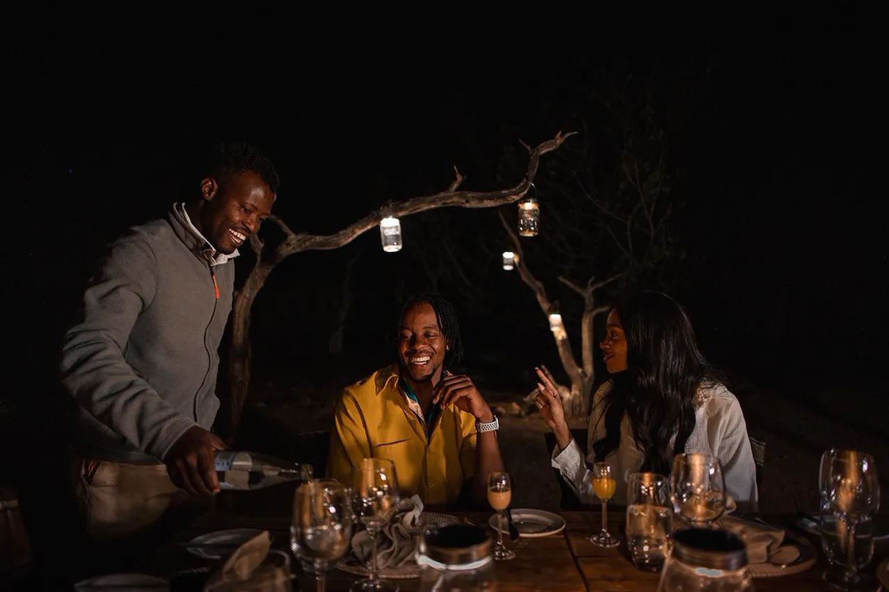 A Bush Dinner Lit by Lantern